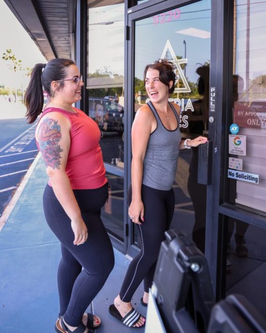 two friends walking into soteria pilates studio in maitland